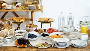 A breakfast buffet with various food items and beverages.