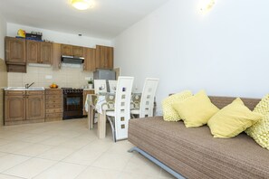 Apartment, 1 Bedroom, Patio (A1) | Living room | Flat-screen TV