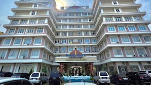 A multi-story building with a prominent Catholic Center sign at the entrance. - Oase Guesthouse (Medan)