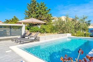 Seasonal outdoor pool, open 9:00 AM to 9:00 PM, pool umbrellas