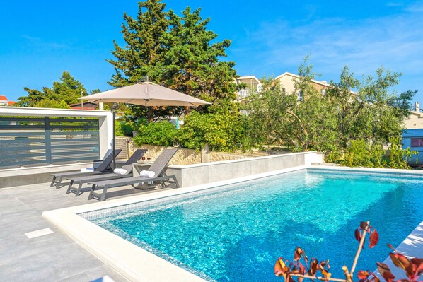 Seasonal outdoor pool, open 9:00 AM to 9:00 PM, pool umbrellas