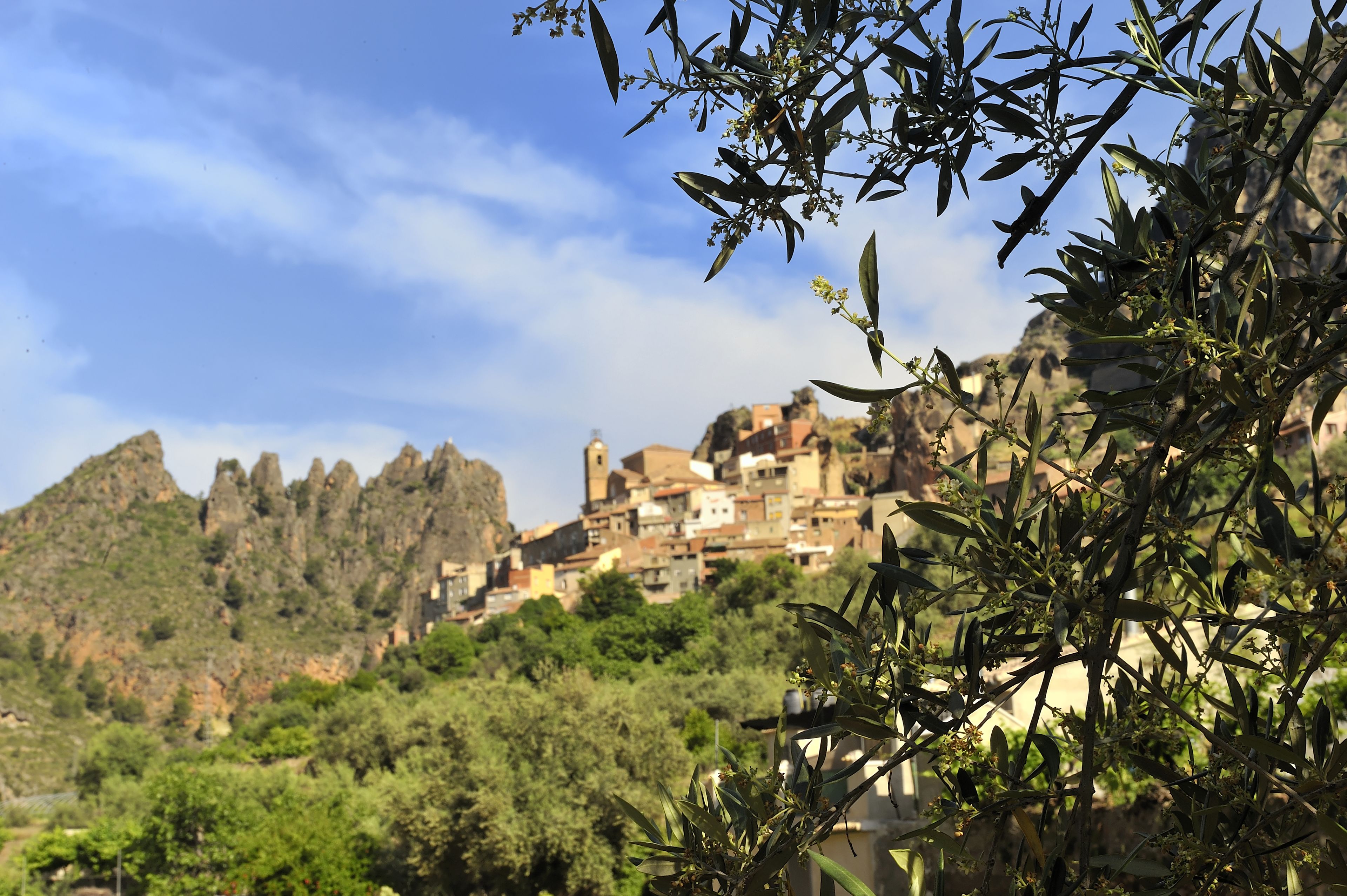 A mountainous town with buildings nestled among the hills.