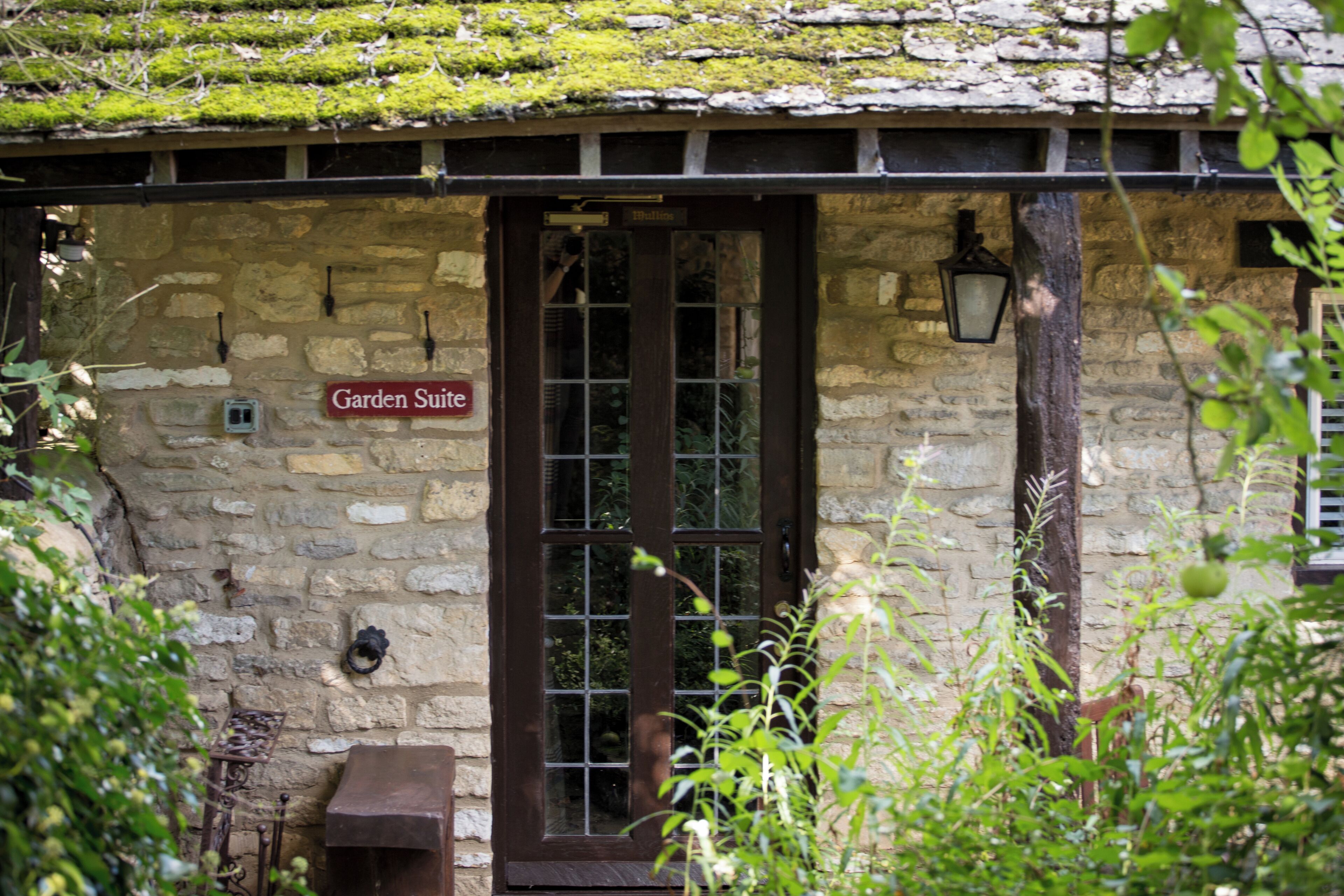 A stone building with a sign reading "Garden Suite."