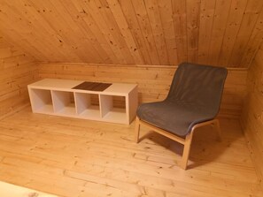 Cozy cabin retreat with a bench and chair for relaxation.