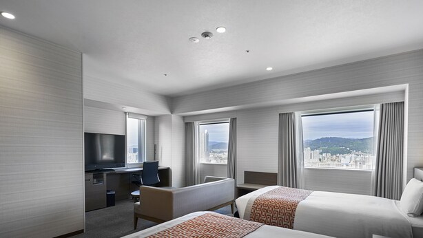 A hotel room with two beds, a desk, a TV, and large windows offering a city view. - Daiwa Roynet Hotel Hiroshima Station (Hiroshima)
