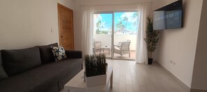 Premium Penthouse, 2 Bedrooms, Pool View | Living room | TV