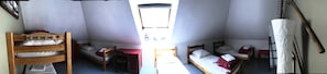A dormitory-style room with bunk beds, a small desk, and a window. - Auberge Gaillard (La Motte-en-Champsaur)