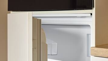 Et åbent køleskab med håndtag, Bosch-logo og transparente hylder.