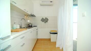 Apartment, Sea View | Private kitchen | Fridge, coffee/tea maker, electric kettle, cleaning supplies