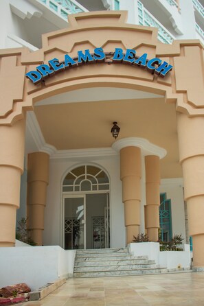 A building entrance with a sign reading "DREAMS BEACH" and a set of marble stairs leading up to a glass door. - Hotel Dreams Beach (Sousse)