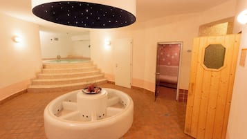Relax in a spacious hot tub surrounded by a tiled floor and a staircase leading to an upper level.