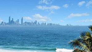 A coastal city skyline with a view of the ocean.