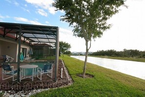 Outdoor dining - A gorgeous lake sunset view villa in a gated High Grove resort near Disney (Clermont)