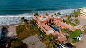 An aerial view of a coastal hotel with a swimming pool, palm trees, and a beach. - Beachfront Delfin Estate with Pool (Sleeps 41) (Mazatlán)