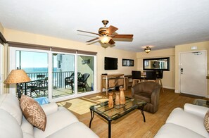 Large living room combined with sliders out to Lanai - spectacular views of world famous Crescent Beach and the Gulf of Mexico.  Large flat panel HDTV, leather sectional...