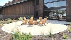 A modern building with a wooden exterior and large glass windows. - Centrally Located Studio Condo, minutes from Main St and Skiing! (Park City)