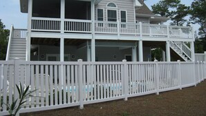 A two-story house with a balcony and a covered porch.