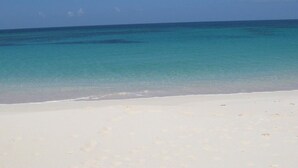 A beach with clear turquoise water and white sand. - Condo w/Views, Beach, Htd Pool, Pickleball, Golf Cart, Gym,Walk to Restaurant (Governors Harbour)