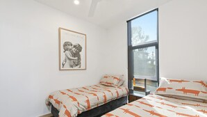 A bedroom with a single bed, a window, and a poster on the wall. - Tucker House (Wye River)
