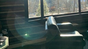 A room with a large window, a sofa, and a television. - Creekside Cabin near falls, casino, golf, & more! (East Stroudsburg)