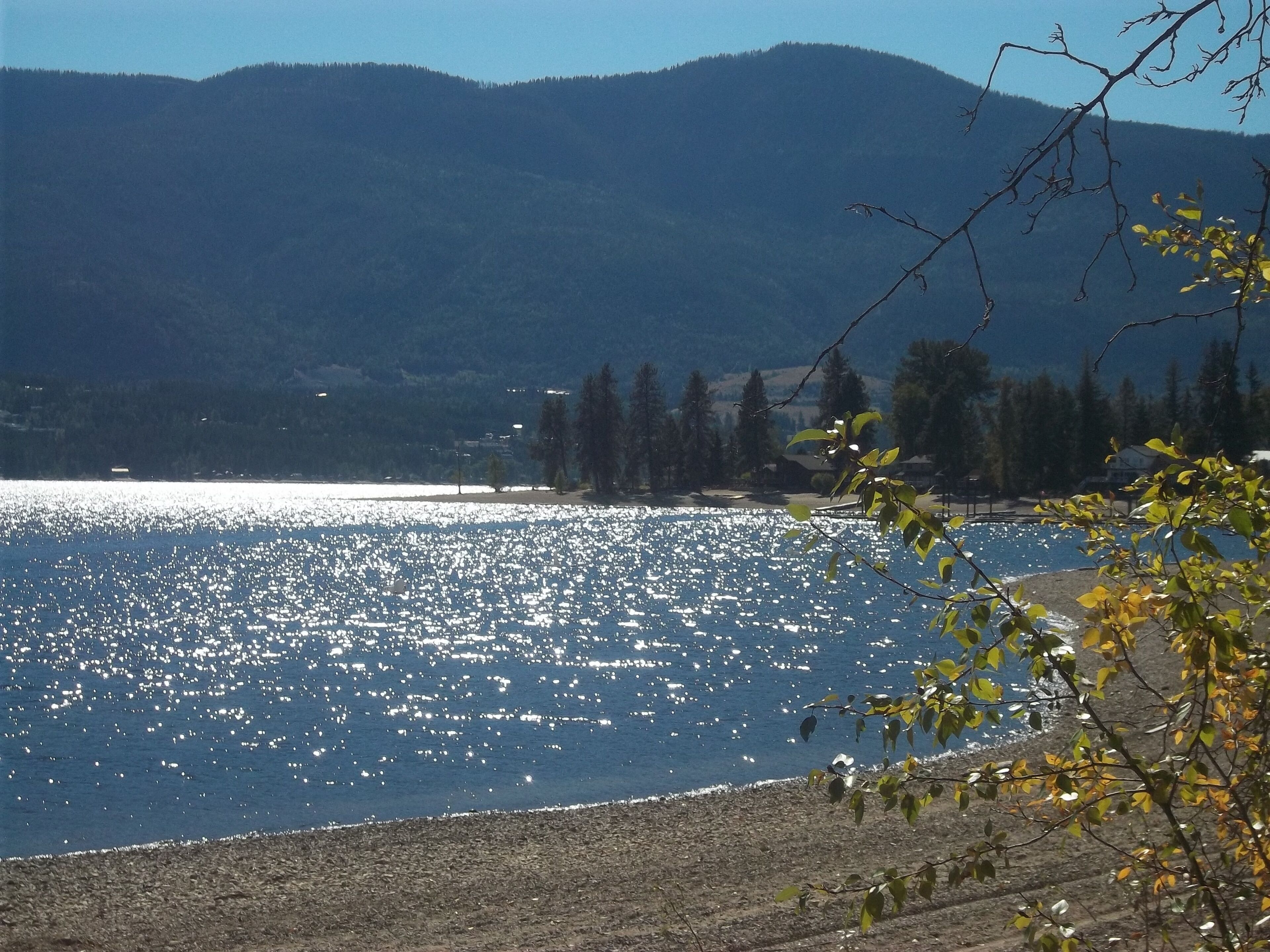 A lake with a clear view of mountains in the background.