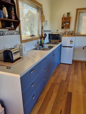A kitchen with a microwave, toaster, and refrigerator. - 19 Blue in Blackmans Bay A Touch of Country in the Suburbs! (Blackmans Bay)