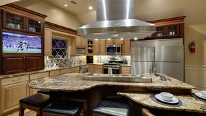 A kitchen with granite countertops, stainless steel appliances, and wooden cabinetry. - Ski-In/Out, 2 Game Theaters, Hibachi Grill, 2 Masters, Hot Tub & Slope Views (Lackawaxen)