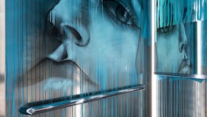 A modern interior with a metallic wall and a glass partition. - JO&JOE Paris - Gentilly Hotel - Hostel (Gentilly)
