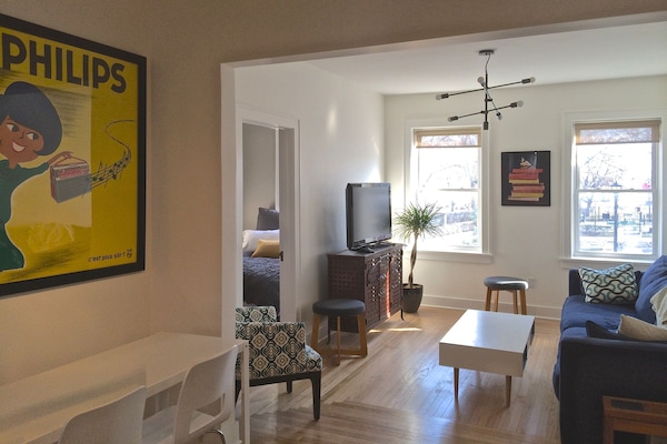 Living room with windows overlooking park.