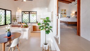 A modern kitchen with a dining area, a large window, and a ceiling fan. - AMAZING Hillside Home, Private Infinity Pool, Covered Veranda, Spacious Rooms (Manuel Antonio)
