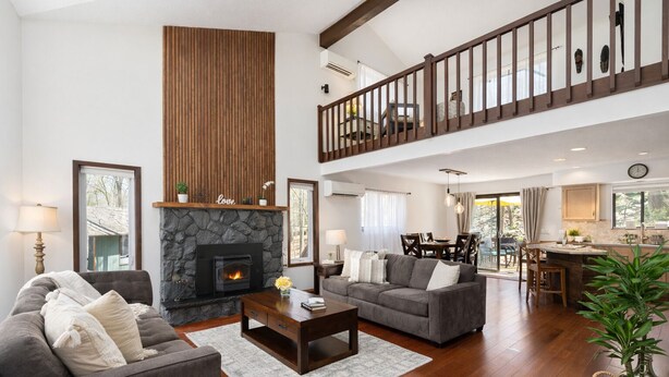 A spacious living area with a fireplace, a dining area, and a kitchen.