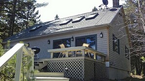 A cabin with a wooden deck, a chimney, and a satellite dish. - Swim and Kayak at this freshwater location. Sleep 6+ on MDI near Acadia National (Seal Cove)
