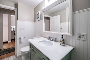 A bathroom with a white sink, green vanity, and a large mirror. - Whether With Family or Friends Shop, Sight See & Dine at Great Restaurants (Portland)