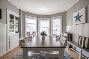 Enjoy meals at the large dining table surrounded by comfortable chairs and a cozy bench.
