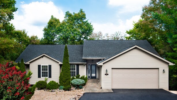 A two-story house with a garage, a front porch, and a driveway. - Beautiful Home,Pool Table,Ping Pong, Air Hockey, Foosball, Views   250.00 (Massanutten)