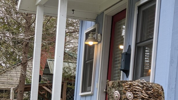A mailbox, a small tree with a carved face, and a house with a red door. - Downtown Bungalow! Dog Friendly -  WIFI!   (Brevard)