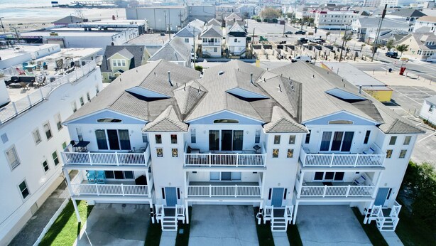 A multi-story residential building with a symmetrical facade, multiple balconies, and a central entrance. - BEACH BLOCK, 100 steps to BOARDWALK and SAND, Sleeps 10 (Wildwood)