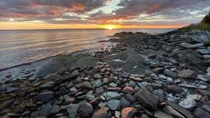 A rocky shoreline with a sunset in the background. - Waterfront, beautiful home, breathless sunsets on Prudence Island (Prudence Island)