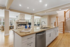 A spacious kitchen with a granite countertop, stainless steel appliances, and a built-in oven. - Lake Michigan Beach Is Across Street, 6 Person Hot Tub, Fire Pit, New Bathrooms (Union Pier)