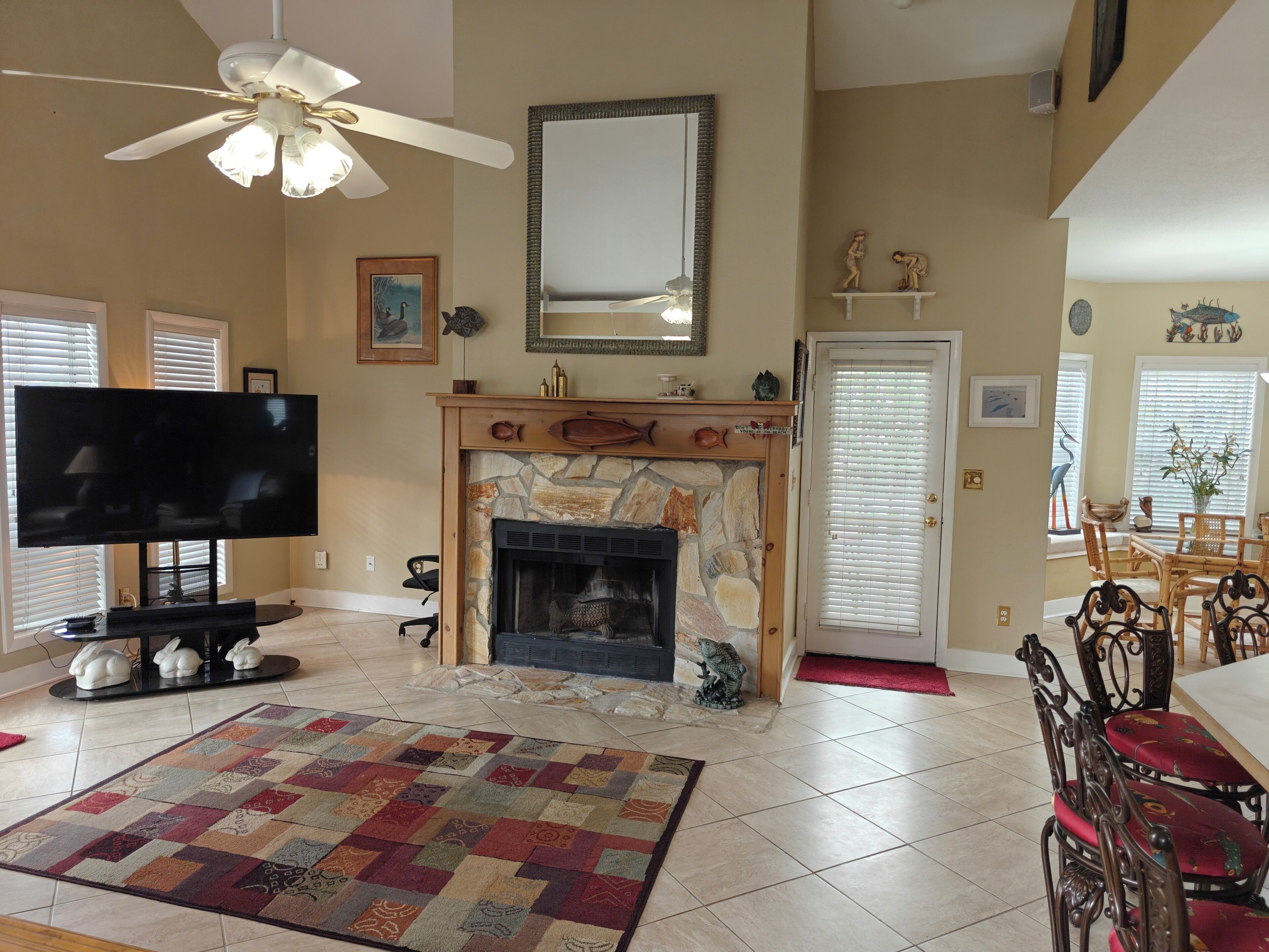 A living room with a fireplace, television, and dining area.