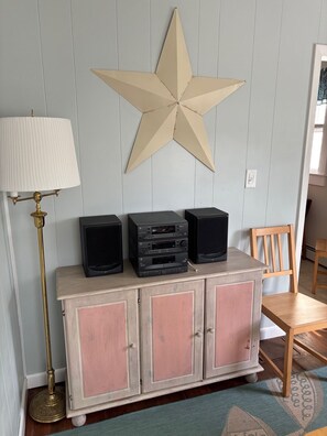 A room with a star decoration, a lamp, and a cabinet with electronic devices. - Now booking summer 2027!  Save 200 dollars off regular peak summer weekly rates! (Old Orchard Beach)