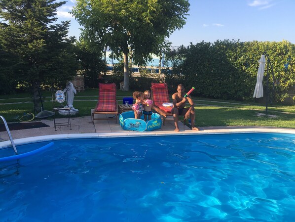 Seasonal outdoor pool, open 9:00 AM to 6:00 PM, pool umbrellas