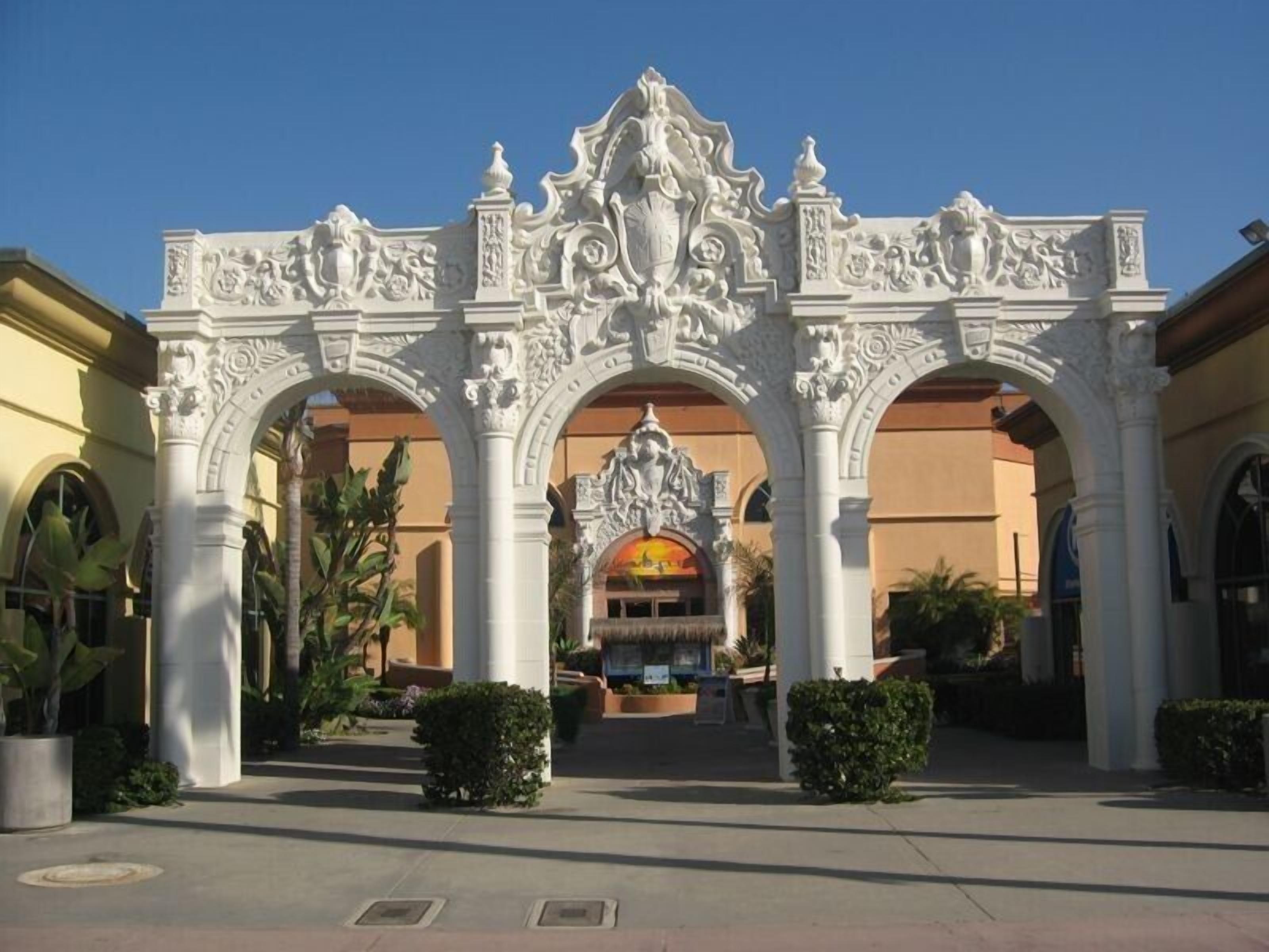 An ornate entrance with intricate carvings and a central statue.