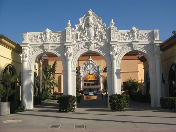 An ornate entrance with intricate carvings and a central statue.