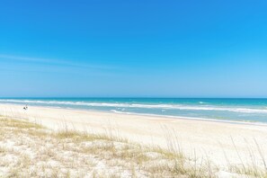 A beach with clear skies and calm waters.