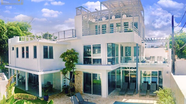 A modern two-story house with a glass facade, outdoor seating, and a pool. - Welcome to the Lucky Penny! (Ocean Park)