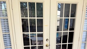 A double door with glass panels, a doormat, and a view of outdoor furniture. - 3 miles Disney, 4 BR/3Ba Pool,Hot tub, game room, Free Wi-Fi,Wheelchair friendly (Kissimmee)