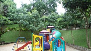 Un parque infantil con diversas estructuras de juego, incluyendo toboganes y juegos de escalar.