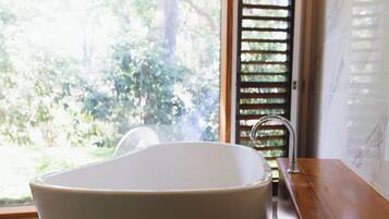 Bathtub, eco-friendly toiletries, hair dryer, towels