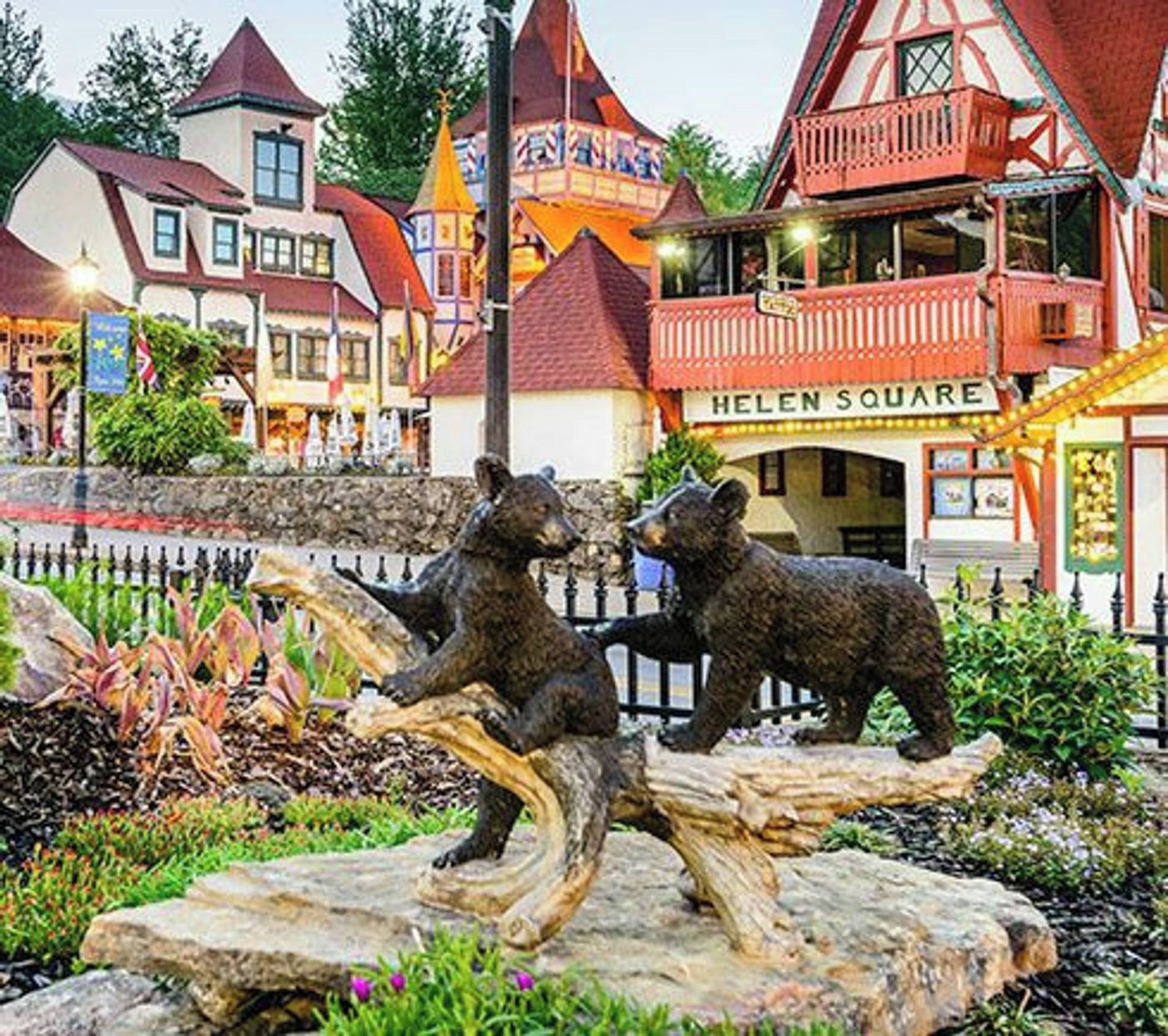 Une statue d’ours dans un jardin, avec un bâtiment portant l’inscription « HELEN SQUARE » en arrière-plan.